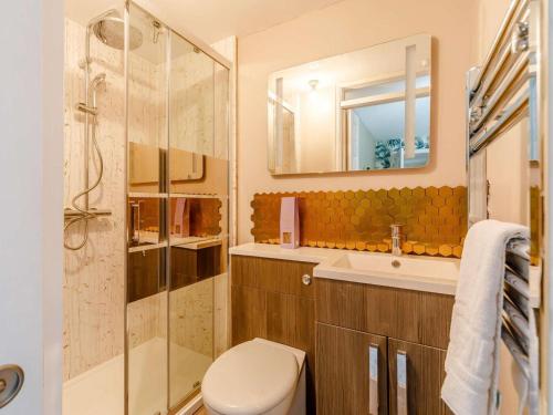a bathroom with a toilet and a sink and a mirror at 5 Bed in Durham oc-85257 in Lanchester
