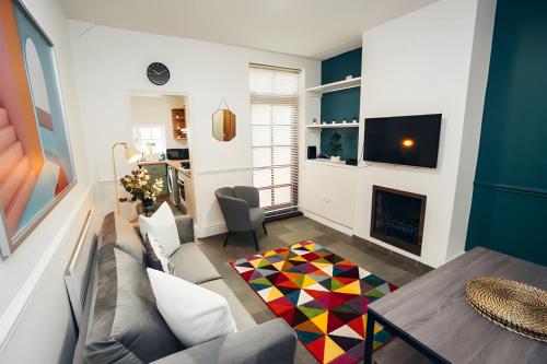 a living room with a couch and a fireplace at 4 Bed House in Central Derby with Parking WiFi Smart TV in Derby