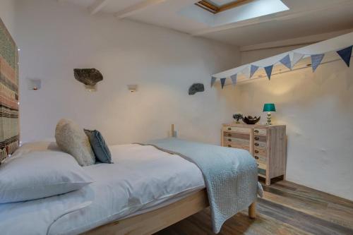 a bedroom with a bed and a wooden dresser at 1 Bed in St. Ives oc-drift4 in St Ives
