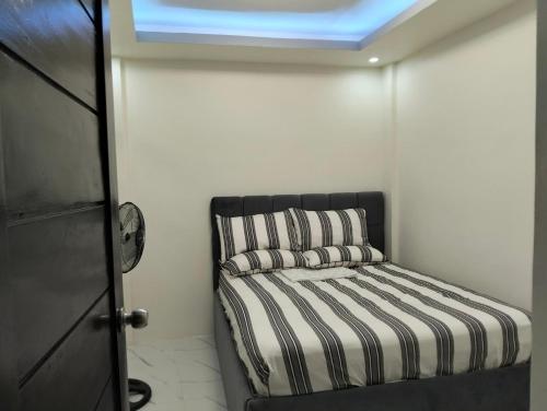 a small bed in a room with a window at Home stay in Pasig in Pasig