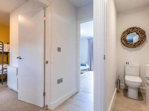 a bathroom with a toilet and a mirror at 2 Bed in Saltash oc-87701 in St. Mellion