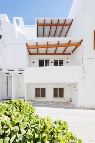 a white house with a roof at Kalypso Vacation Home Naxos Town in Naxos Chora