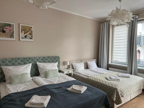 a bedroom with two beds with towels on them at Chopin's Apartment in Bielsko-Biała