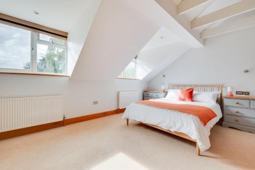 a white bedroom with a bed and a window at 5 Bed in Walberswick oc-troy in Walberswick