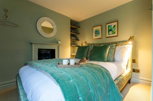 a bedroom with a large bed with green walls at Old Orchard Elegance - Private Parking in Bath