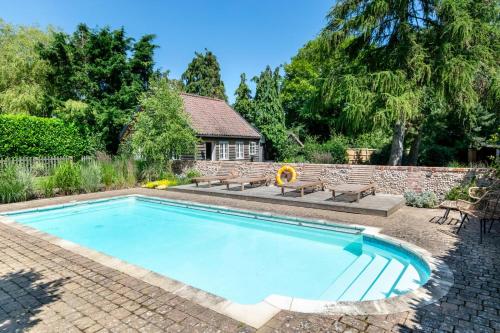 a swimming pool in a yard with a brick wall at 5 Bed in Walberswick oc-troy in Walberswick