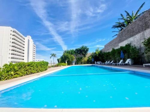 a swimming pool with blue water in a resort at Apartment with balcony overlooking crystal-clear lagoon and in Mazatlán