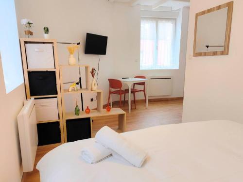 a bedroom with a bed and a table with a chair at L'Horizon - AbsoluteHome in Croix