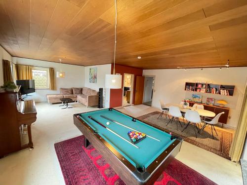 a living room with a pool table in it at 4-bedroom family villa, bath tub, billiards, piano, and fun board games in Rødby