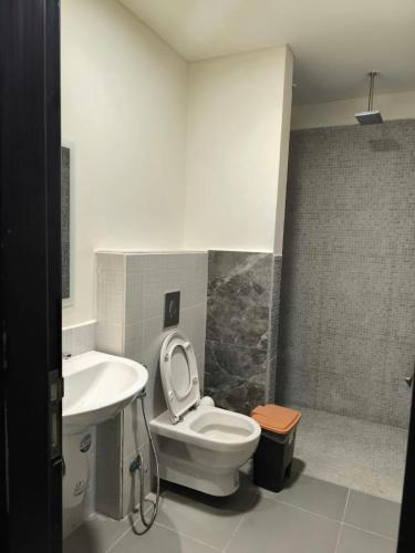 a bathroom with a toilet and a sink at EP1 TWO BEDROOM APARTMENT AT Samarah Resort in Sowayma