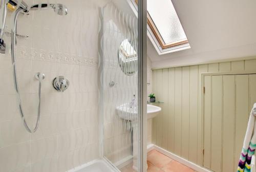 a bathroom with a shower and a sink at 3 Bed in Craster oc-79891 in Craster