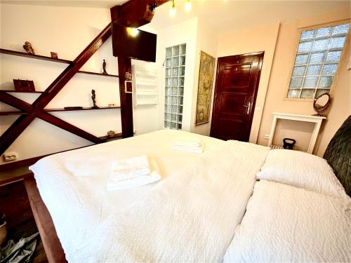 a bedroom with a white bed with two napkins on it at La Mansardă in Câmpulung