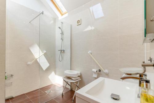 a white bathroom with a shower and a sink at 1 Bed in Wonastow oc-l29426 in Wonastow