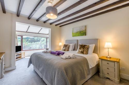 a bedroom with a large bed and a window at 5 Bed in Clows Top oc-m32976 in Bayton