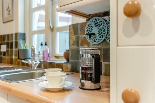 a kitchen counter with a coffee maker on a counter top at 2 Bed in Weobley oc-c32945 in Weobley