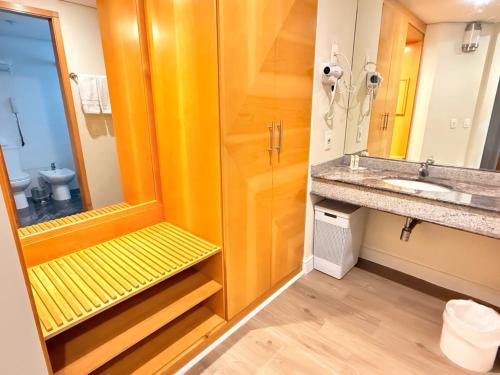 a bathroom with a shower and a sink and a mirror at Hotel & Residence Alphaville in Barueri