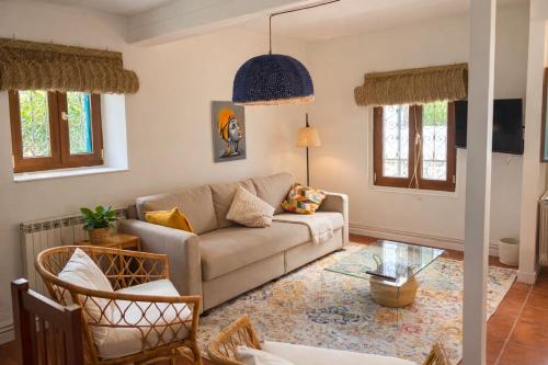 a living room with a couch and a glass table at La casina de Barro in Llanes