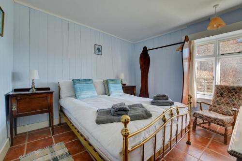 a bedroom with a bed and a chair and a window at 2 Bed in Bacton oc-710 in Bacton