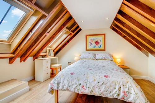a bedroom with a bed and some windows at 3 Bed in Llanrwst oc-wag689 in Llanrwst