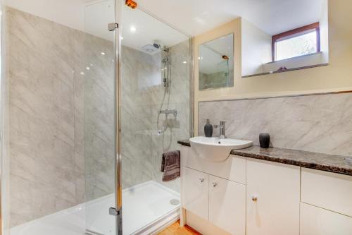 a bathroom with a shower and a sink at 3 Bed in Llanrwst oc-wag689 in Llanrwst
