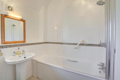 a white bathroom with a tub and a sink at 2 Bed in Roughton oc-1626 in Roughton
