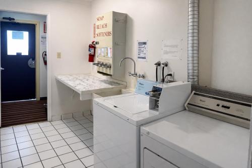a kitchen with white counter tops and a blue door at Granada Hotel Santa Clara in Santa Clara