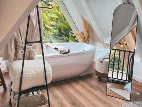 a bathroom with a bath tub and a window at Chalé Villa Mount in Timbe do Sul