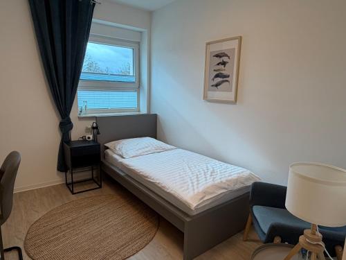 a small bedroom with a bed and a window at City Inn Schwedt in Schwedt
