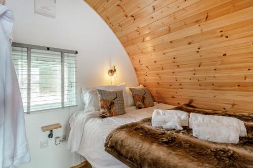a bedroom with a large bed in a wooden wall at 1 Bed in Langtoft oc-l32679 in Langtoft