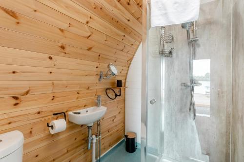 a bathroom with wooden walls and a sink and a shower at 1 Bed in Langtoft oc-l32679 in Langtoft
