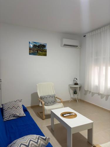 a living room with a couch and a coffee table at Casa 22 in Plasencia