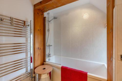 a bathroom with a tub and a red towel at 2 Bed in Woofferton oc-b29941 in Woofferton