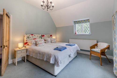 a bedroom with a bed and a chair and a window at 2 Bed in Woofferton oc-b29941 in Woofferton