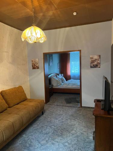 a living room with a couch and a bedroom at Ruheoase in Konz-Könen in Konz