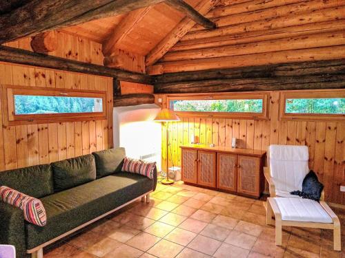 a living room with a couch and chairs in a cabin at Holiday Home Rustico Enrico by Interhome in Campo Blenio