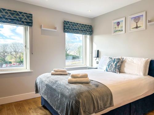 a bedroom with a bed with two towels on it at Central Haven Dingle in Dingle