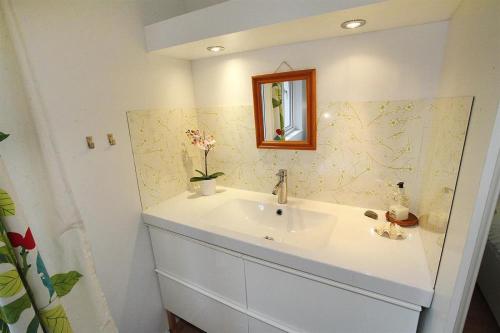 a bathroom with a white sink and a mirror at 3 Bed in Mumbles oc-hh19 in The Mumbles