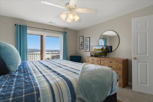 a bedroom with a bed and a mirror and a window at Serenity Now Retreat in Camdenton