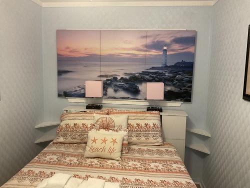 a bedroom with a bed with a picture on the wall at Beach Skybox HHI in Hilton Head Island
