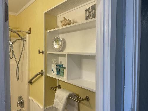 a bathroom with a shelf with a clock on it at Beach Skybox HHI in Hilton Head Island