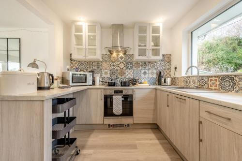 a kitchen with a sink and a stove top oven at 2 Bed in Wareham oc-79228 in West Lulworth