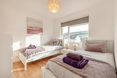a bedroom with two beds and a window at 2 Bed in Wareham oc-79228 in West Lulworth