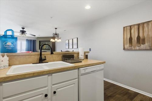 a kitchen counter with a sink and a mirror at Serenity Now Retreat in Camdenton