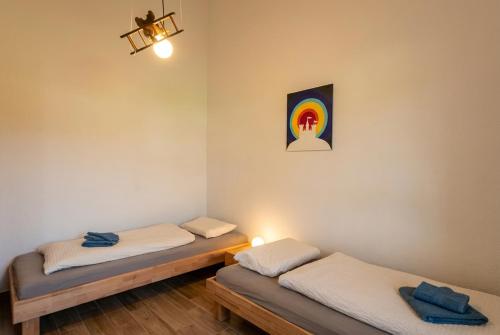 two twin beds in a room with a rainbow on the wall at Haus Dornröschen in Schweiburg