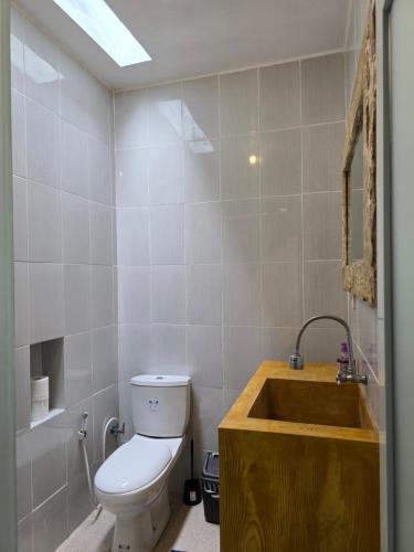 a bathroom with a toilet and a sink at Rumah Risa in Tanah Lot