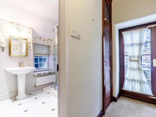 a bathroom with a sink and a window at 2 Bed in Matlock oc-81043 in Winster