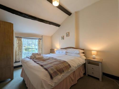 a bedroom with a bed with a teddy bear on it at 2 Bed in Cockermouth oc-sz136 in Lorton