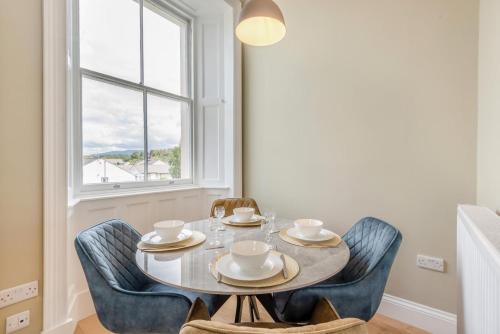 a dining room with a table and chairs and a window at 2 Bed in Cockermouth oc-m32942 in Cockermouth