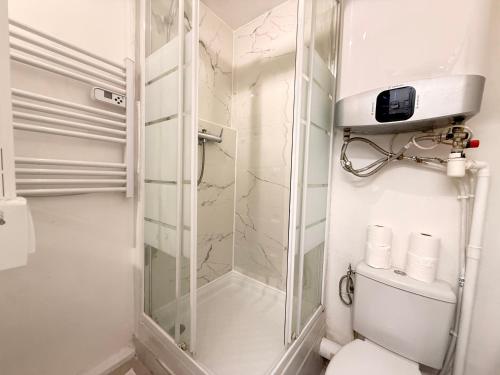 a bathroom with a glass shower and a toilet at BEAUTY SAINT PAUL renovated February 2026 in Paris