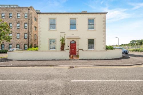 a building with a red door on a street at 2 Bed in Cockermouth oc-m32942 in Cockermouth